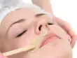 Visage de femme allongée les yeux fermés avec un bâtonnet au niveau des lèvres